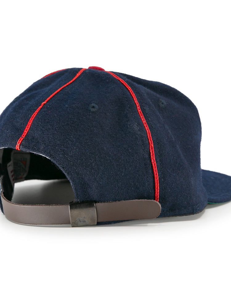 The EFF Danville Veterans 1932 Vintage Ballcap is a navy blue baseball cap with red panel stitching, seen from the back with an adjustable brown leather strap and metal buckle.