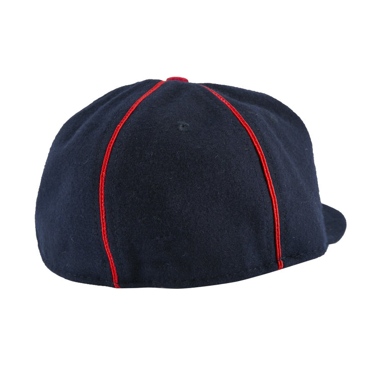The EFF Danville Veterans 1932 Vintage Ballcap in navy blue is shown from the back, highlighting red vertical seams and a glimpse of the curved brim visible on the right.
