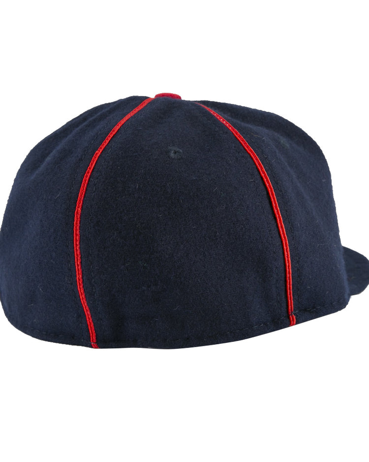 The EFF Danville Veterans 1932 Vintage Ballcap in navy blue is shown from the back, highlighting red vertical seams and a glimpse of the curved brim visible on the right.