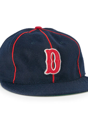 The EFF Danville Veterans 1932 Vintage Ballcap is a navy blue wool hat with red piping, a red and white outlined letter D, flat brim, and classic red button—ideal for collectors of historic ballcaps.