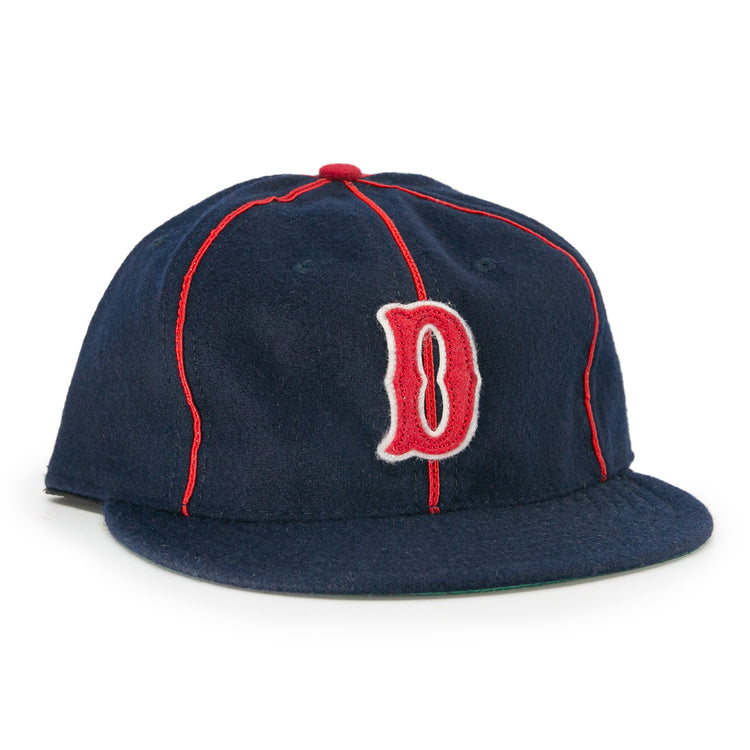 The EFF Danville Veterans 1932 Vintage Ballcap is a navy blue wool hat with red piping, a red and white outlined letter D, flat brim, and classic red button—ideal for collectors of historic ballcaps.