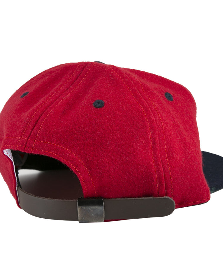 The EFF Deland Red Hats 1939 Vintage Ballcap in red features black ventilation eyelets and an adjustable black strap with metal clasp, crafted from genuine wool baseball cloth in classic ballcap style.