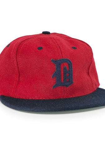 The EFF Deland Red Hats 1939 Vintage Ballcap features genuine wool, a red crown, dark blue brim, and a stylized dark blue D—a classic design inspired by the original Deland Red Hats baseball cap.
