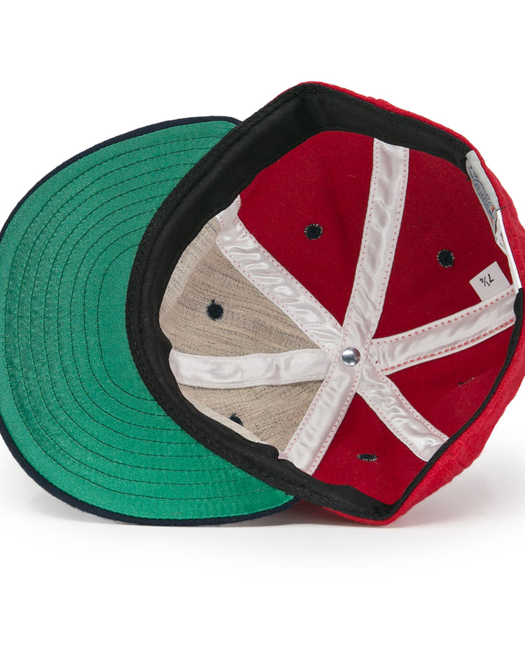 The EFF Deland Red Hats 1939 Vintage Ballcap, size XL, is turned inside out to reveal its green brim, black-and-white inner seams, white size tag, and black ventilation holes on the wool lining.