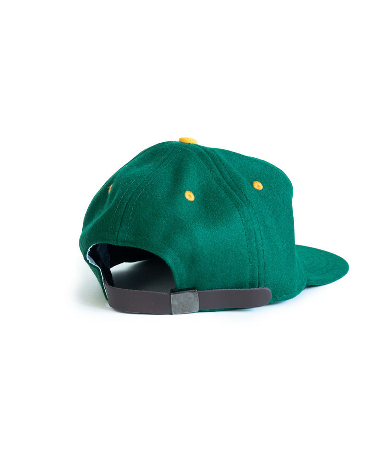 The EFF University of San Francisco 1950 Vintage Ballcap is shown from the back, featuring green wool, yellow eyelets, and a brown adjustable strap against a white background.