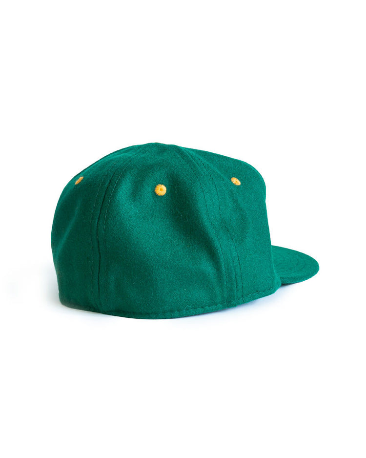 The EFF University of San Francisco 1950 Vintage Ballcap is green with a flat brim, yellow eyelets, and is pictured from the back at an angle against a plain white background.