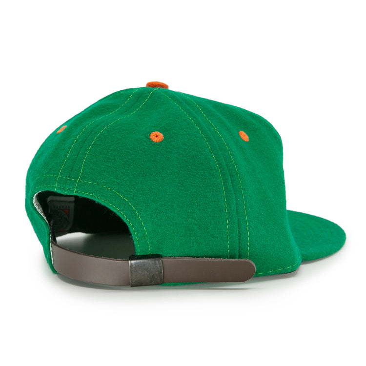 The EFF Dublin Green Sox 1951 Vintage Ballcap features orange eyelets and a brown adjustable strap with metal buckle, delivering retro style from the back view.