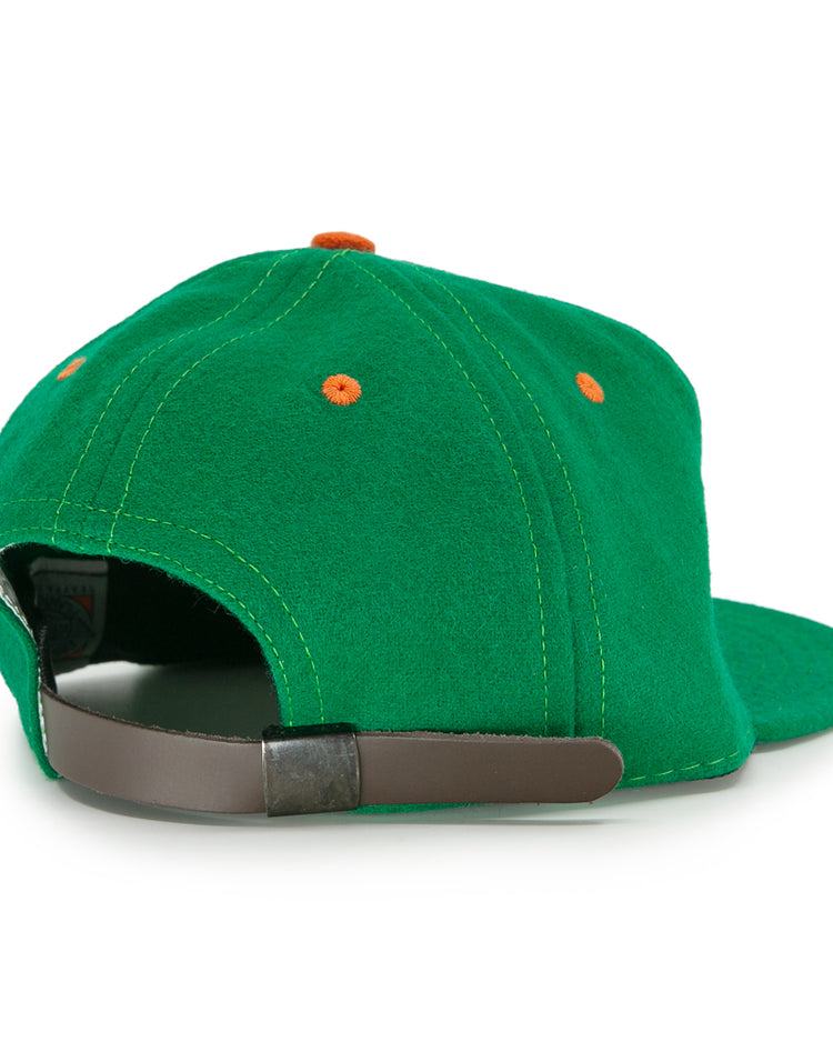 The EFF Dublin Green Sox 1951 Vintage Ballcap features orange eyelets and a brown adjustable strap with metal buckle, delivering retro style from the back view.