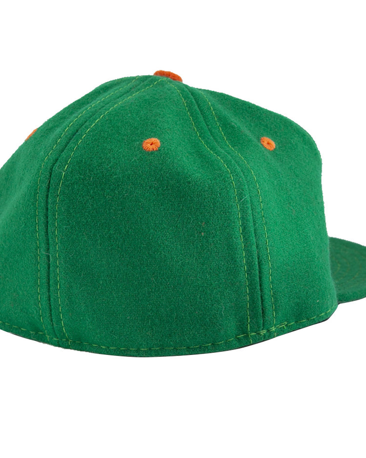 The EFF Dublin Green Sox 1951 Vintage Ballcap, shown from the back and slightly to the side, features green fabric with orange stitched eyelets.