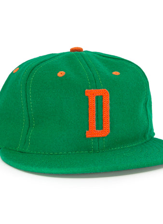 The EFF Dublin Green Sox 1951 Vintage Ballcap features a green body with an orange D front logo plus orange accents on the top button and ventilation holes.