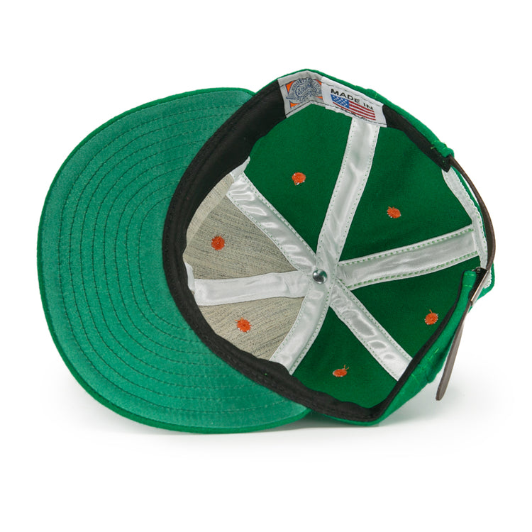 An authentic Dublin Green Sox 1951 Vintage Ballcap by EFF, viewed from below, reveals white stitched panels, orange seam dots, a metal crown button, and a Made in USA label.