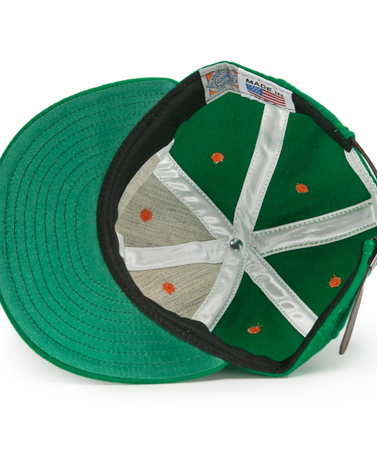 An authentic Dublin Green Sox 1951 Vintage Ballcap by EFF, viewed from below, reveals white stitched panels, orange seam dots, a metal crown button, and a Made in USA label.