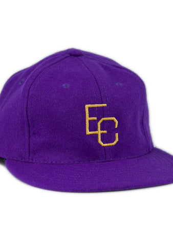 The Ebbets Field Flannels East Carolina University 1961 Vintage Ballcap is a purple wool cap with interlocking yellow EC letters on the front, shown at a slight angle against a white background.