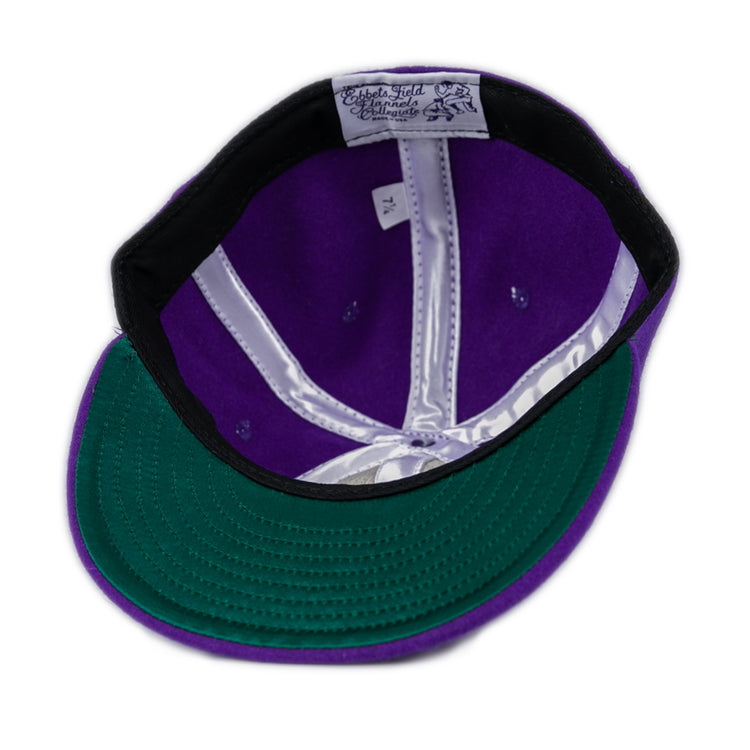 The East Carolina University 1961 Vintage Ballcap by Ebbets Field Flannels is shown from the inside, highlighting the green underside of the brim, a white sweatband, a 7 1/4 size tag, and shiny white interior lining.