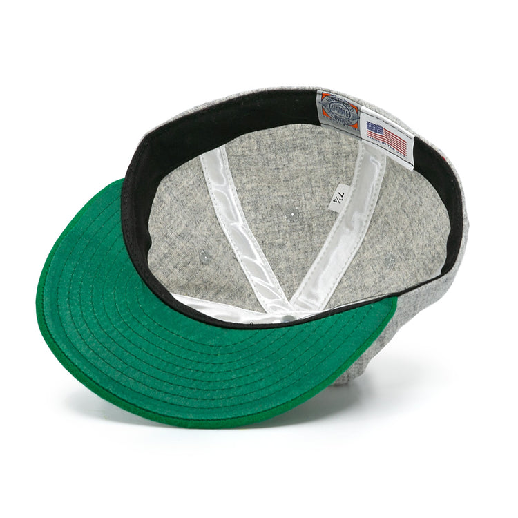 The Cienfuegos Elefantes 1946 Vintage Ballcap by Ebbets Field Flannels features a green underside brim, white sweatband, and a tag with size 7 1/4, branding, and an American flag—classic Cuban Professional League details.