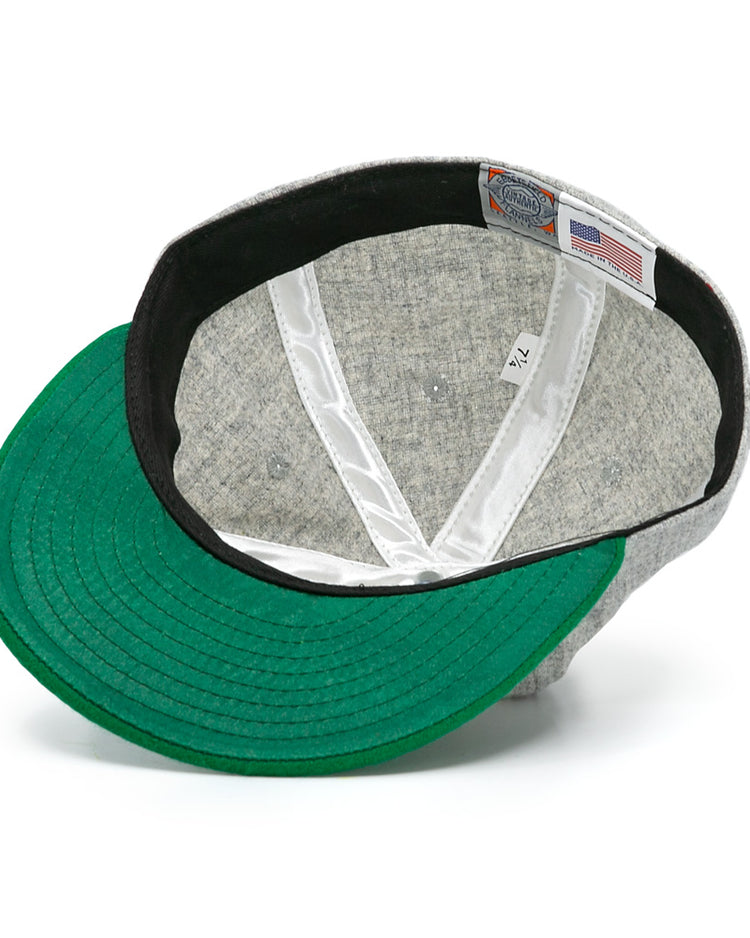 The Cienfuegos Elefantes 1946 Vintage Ballcap by Ebbets Field Flannels features a green underside brim, white sweatband, and a tag with size 7 1/4, branding, and an American flag—classic Cuban Professional League details.