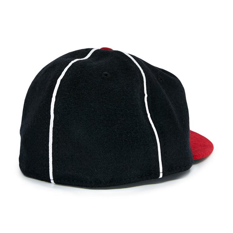 The EFF Escogido Leones 1952 Vintage Ballcap is a black cap with two white vertical stripes and a red brim, shown from the back.