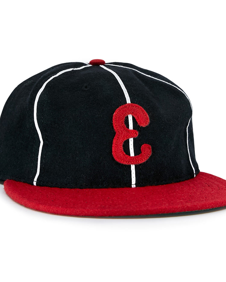 The EFF Escogido Leones 1952 Vintage Ballcap is a black cap with thin white stripes, a red brim, and a bold red E on the front—authentically recreating the Dominican League classic.