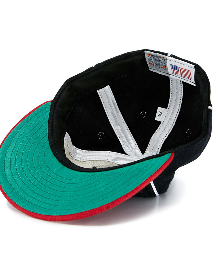 A look inside the EFF Escogido Leones 1952 Vintage Ballcap shows a green underbill, red brim trim, white interior seams, ventilation holes, and an American flag tag next to a size label reading 7 1/4.