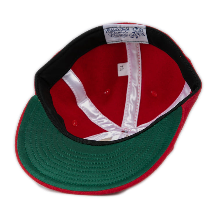 The Ebbets Field Flannels Fresno State University 1951 Vintage Ballcap is shown from above, revealing its white satin lining, sweatband with visible stitching, a top label, and a green underside on the authentic wool brim.