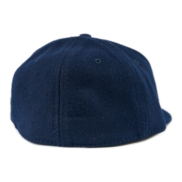 The Ebbets Field Flannels Fresno State University 1958 Vintage Ballcap in dark blue is shown from the back, highlighting its rounded crown and strapless design.