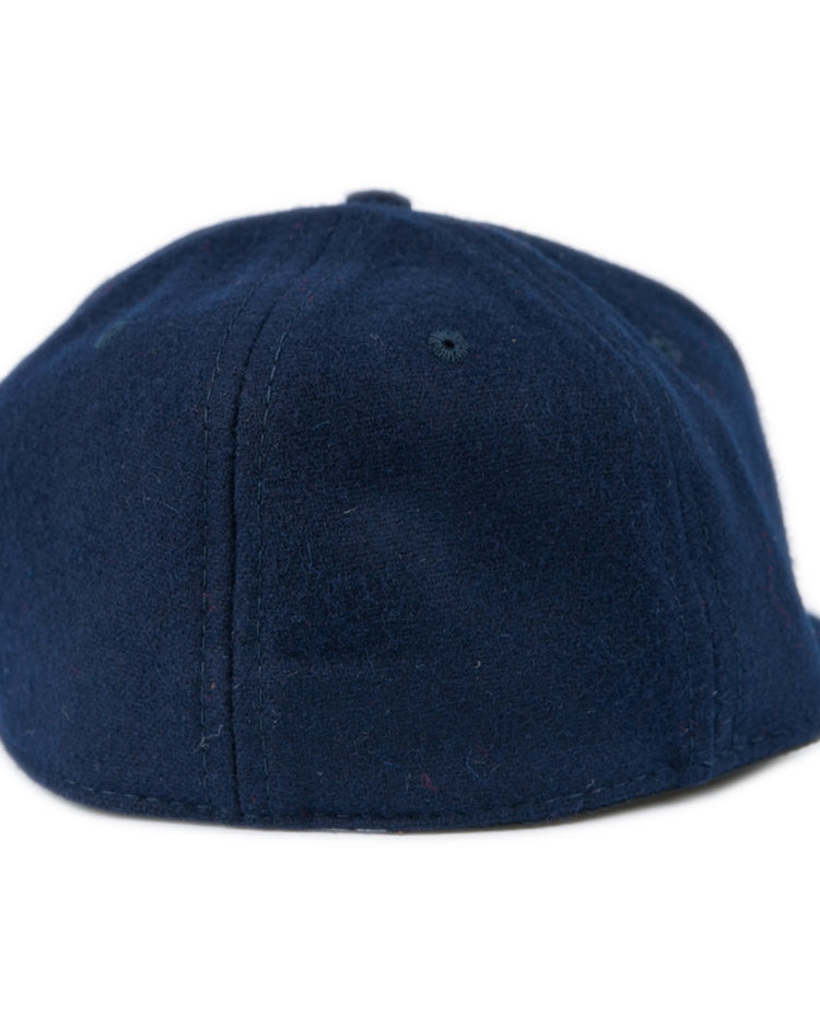 The Ebbets Field Flannels Fresno State University 1958 Vintage Ballcap in dark blue is shown from the back, highlighting its rounded crown and strapless design.