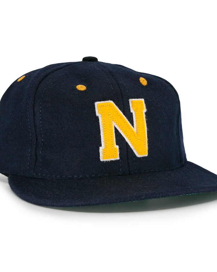 The EFF Great Lakes Naval Station 1944 Vintage Ballcap is a navy wool cap with yellow ventilation accents and a bold yellow N on the front, inspired by an authentic 1944 baseball design.