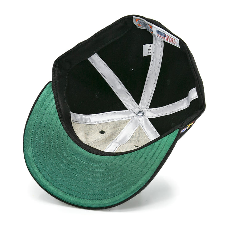 The image shows the inside of an EFF Galt Terriers 1961 Vintage Ballcap, featuring a green underbrim, white sweatband, visible stitching, and interior size and manufacturing labels inspired by classic Ontario Senior Hockey League styles.