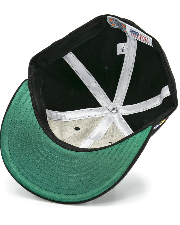 The image shows the inside of an EFF Galt Terriers 1961 Vintage Ballcap, featuring a green underbrim, white sweatband, visible stitching, and interior size and manufacturing labels inspired by classic Ontario Senior Hockey League styles.