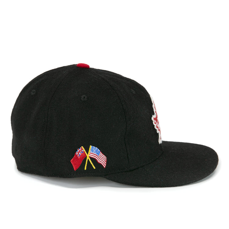 The EFF Galt Terriers 1961 Vintage Ballcap is a black wool baseball cap with crossed British Red Ensign and American flag embroidery, red top button, and flat brim—ideal for Ontario Senior Hockey League or Allan Cup fans.