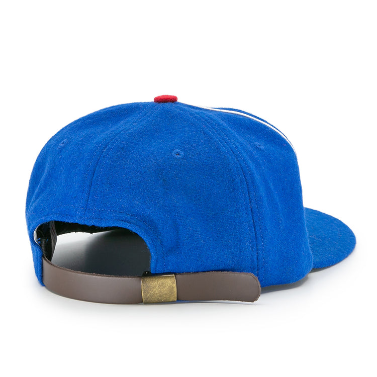 The Houston Buffs 1960 Vintage Ballcap by EFF is shown from the back, featuring a brown adjustable strap with brass clasp. Made of genuine wool baseball cloth, it has a red top button and curved brim.