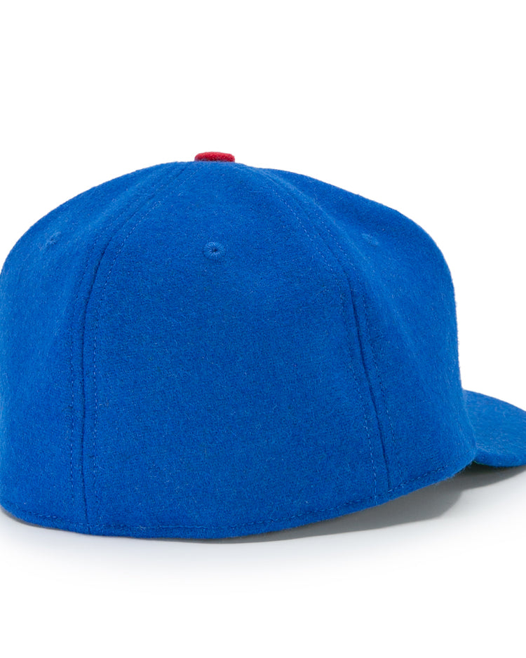 The Houston Buffs 1960 Vintage Ballcap by EFF is a bright blue wool cap with a rounded crown, flat brim, small red top button, and no logos or adjustment straps, viewed from the back.