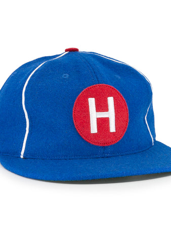 The EFF Houston Buffs 1960 Vintage Ballcap features blue wool baseball cloth, white piping, a red top button, and a front red patch with a white H—authentic to the classic 1960 team style.