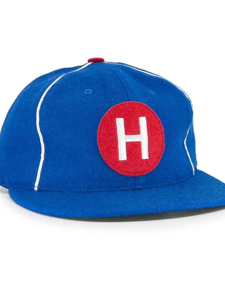 The EFF Houston Buffs 1960 Vintage Ballcap features blue wool baseball cloth, white piping, a red top button, and a front red patch with a white H—authentic to the classic 1960 team style.
