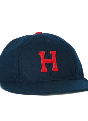 The EFF Houston Buffs 1932 Vintage 8-Panel Ballcap is a navy wool cap featuring a red embroidered H on the front and a red top button, inspired by the classic 1932 design.