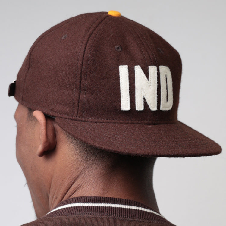 A person wearing the EFF Independent Subway System 1939 Vintage Ballcap, featuring bold white IND letters on the back, is shown from behind against a plain light background.