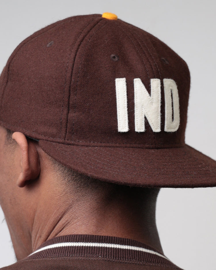 A person wearing the EFF Independent Subway System 1939 Vintage Ballcap, featuring bold white IND letters on the back, is shown from behind against a plain light background.