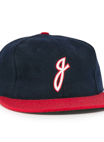 The Ebbets Field Flannels Jacksonville Braves 1953 Vintage Ballcap features navy wool, a red brim, and a white embroidered J outlined in red, inspired by the original 1953 team design.