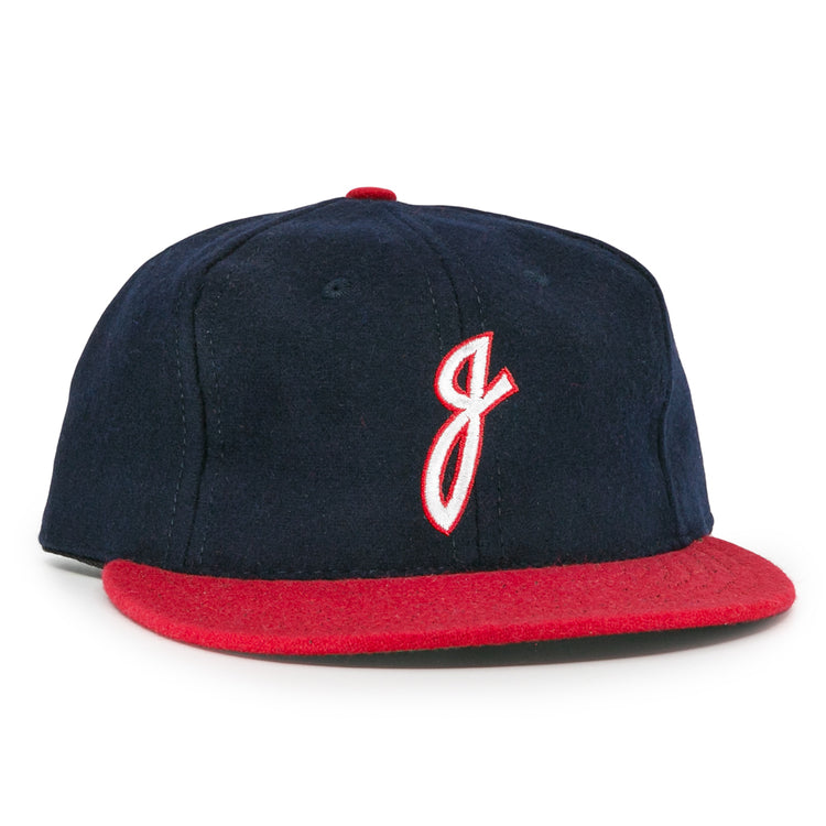 The Ebbets Field Flannels Jacksonville Braves 1953 Vintage Ballcap features navy wool, a red brim, and a white embroidered J outlined in red, inspired by the original 1953 team design.