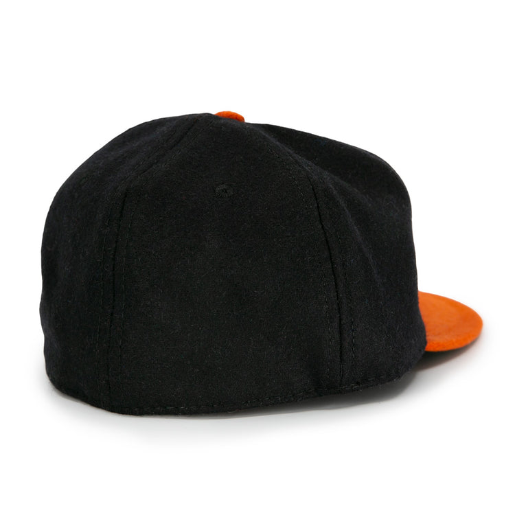 The EFF Jersey City Skeeters 1928 Vintage Ballcap is a black wool cap with an orange brim and top button, shown from the back at a slight angle.