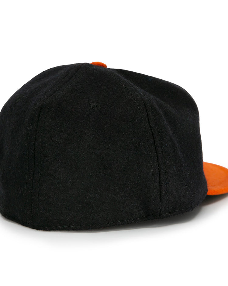 The EFF Jersey City Skeeters 1928 Vintage Ballcap is a black wool cap with an orange brim and top button, shown from the back at a slight angle.