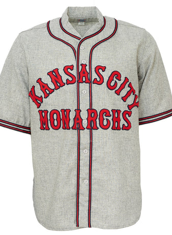 The EFF Kansas City Monarchs 1936 Road Jersey is a gray vintage-style baseball flannel with red and black trim, featuring bold KANSAS CITY above MONARCHS, inspired by classic Negro Leagues jerseys.