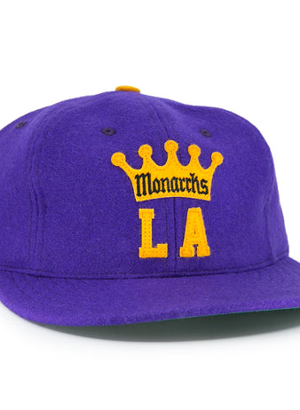 The EFF Los Angeles Monarchs 1947 Vintage Ballcap features a purple wool base, yellow crown, “Monarchs” over bold yellow LA lettering on the front, and a small black and yellow patch on the left side.
