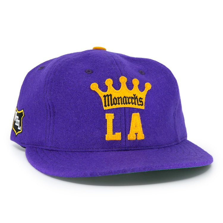 The EFF Los Angeles Monarchs 1947 Vintage Ballcap features a purple wool base, yellow crown, “Monarchs” over bold yellow LA lettering on the front, and a small black and yellow patch on the left side.