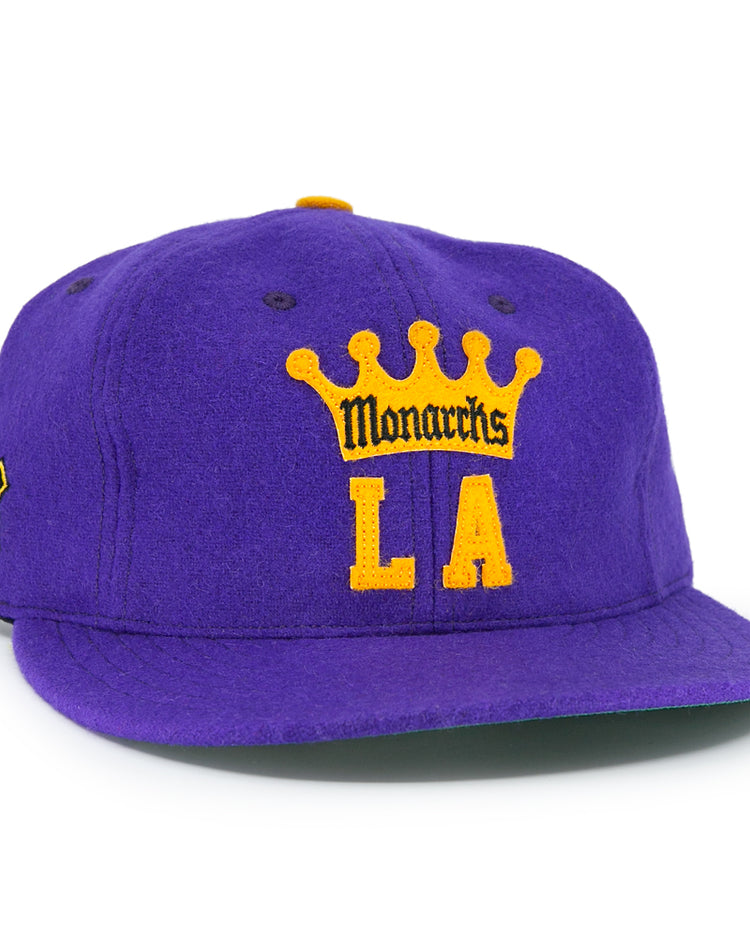 The EFF Los Angeles Monarchs 1947 Vintage Ballcap features a purple wool base, yellow crown, “Monarchs” over bold yellow LA lettering on the front, and a small black and yellow patch on the left side.