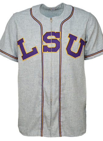 The EFF Louisiana State University 1954 Home Jersey is a gray short-sleeve baseball jersey with purple and gold lettering, black-trimmed piping, and an authentic design inspired by College World Series champions.