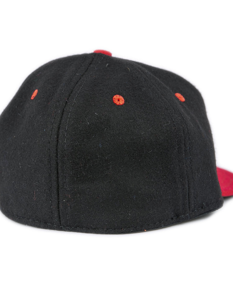 The EFF University of Maryland 1939 Vintage Ballcap is a black cap with red ventilation holes and a striking red brim, shown from the back.