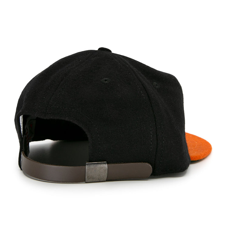 The Marianao Tigres 1950 Vintage Ballcap by Ebbets Field Flannels features a black and orange design, classic brown adjustable strap with metal clasp, and is inspired by the Cuban Professional League.