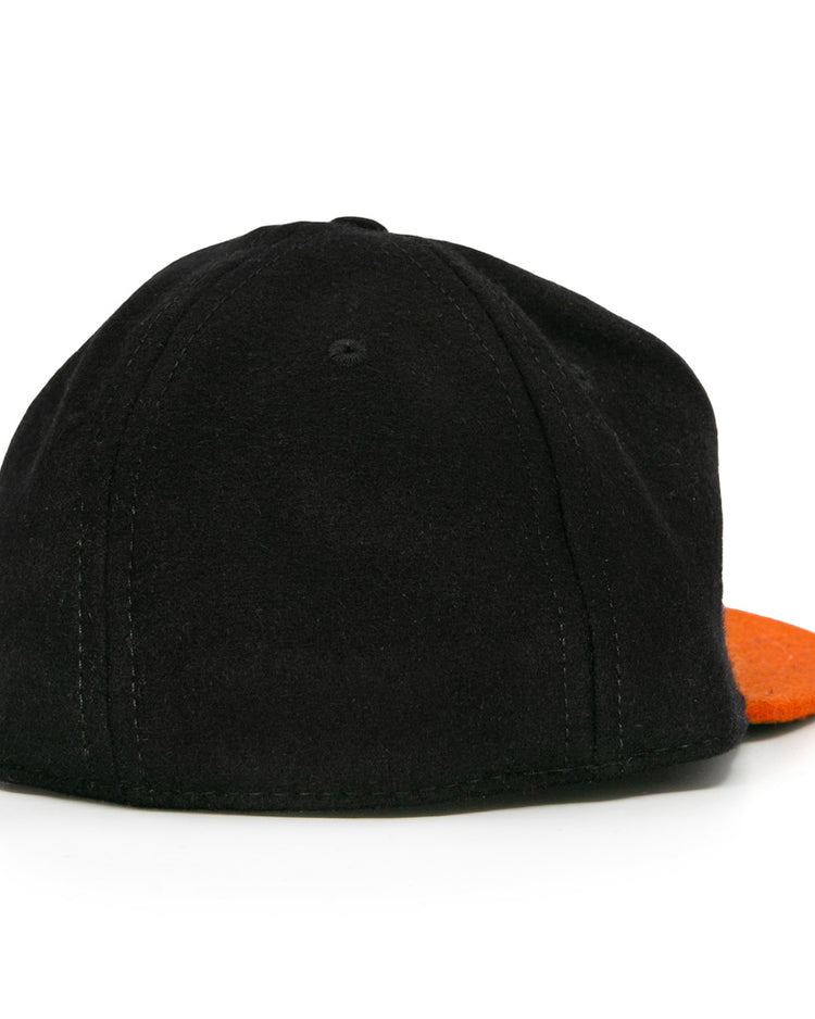 The Marianao Tigres 1950 Vintage Ballcap by Ebbets Field Flannels is shown from the back, highlighting visible stitching and an orange brim at the front—a tribute to classic Cuban Professional League baseball hat designs.