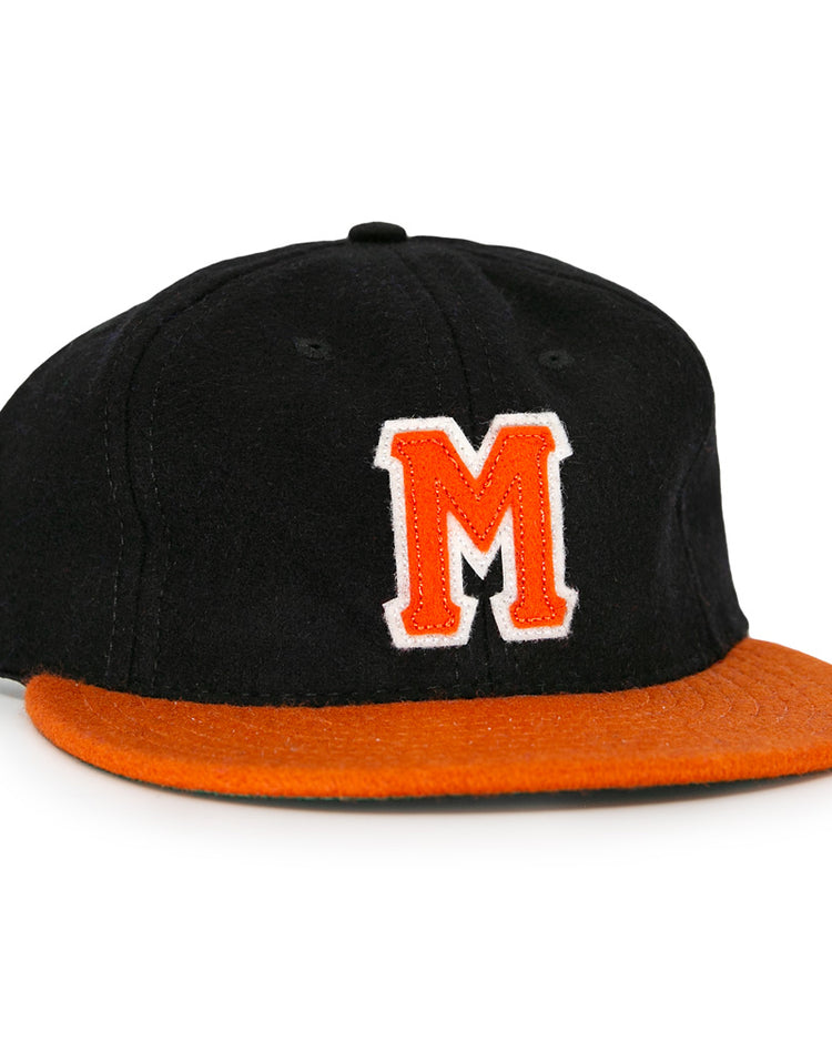 The Marianao Tigres 1950 Vintage Ballcap by Ebbets Field Flannels features a black crown, orange brim, and striking orange M outlined in white, capturing the iconic style of the Cuban Professional League team.